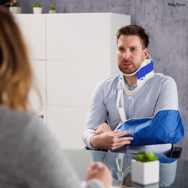 Injured man wearing a neck brace and arm sling while discussing his injuries, representing medical documentation that may support a car accident injury claim.
