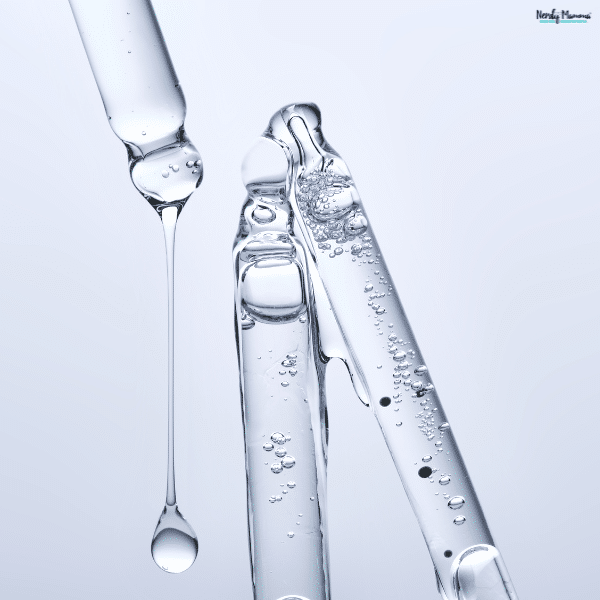 Laboratory pipette releasing a clear liquid beside glass tubes, representing peptide testing and quality evaluation for research.