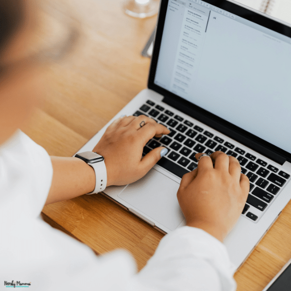 Person typing on a laptop while managing email data and online outreach tasks for an email enrichment campaign.