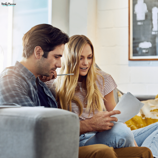 Couple reviewing financial documents together while making smarter decisions about their household budget and future goals.