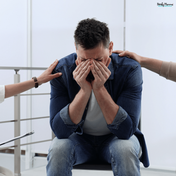 Man receiving emotional support during a difficult conversation, representing how families can provide care before and during a loved one’s rehab stay.
