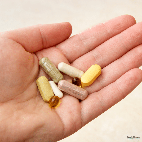 A hand holds several tablets and capsules, illustrating the range of science-backed supplements available.