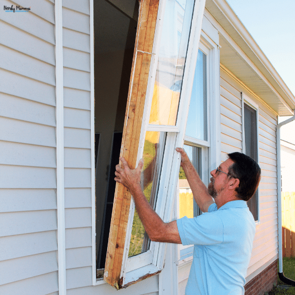 Installer removing an old window from a Nashville home as part of a residential window replacement project.