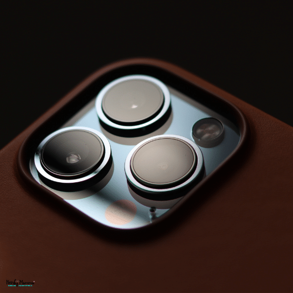 Brown case shown in close-up around three metallic-rimmed camera lenses, illustrating the refined style of iPhone duo cases.