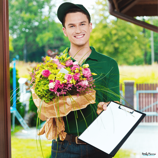 A delivery worker holds a bouquet of pink roses and green blooms, illustrating choosing the right flowers as a thoughtful gift.