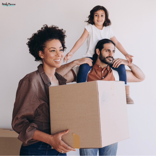A woman carries a cardboard box while a man holds a child on his shoulders as the family prepares for a smooth relocation.
