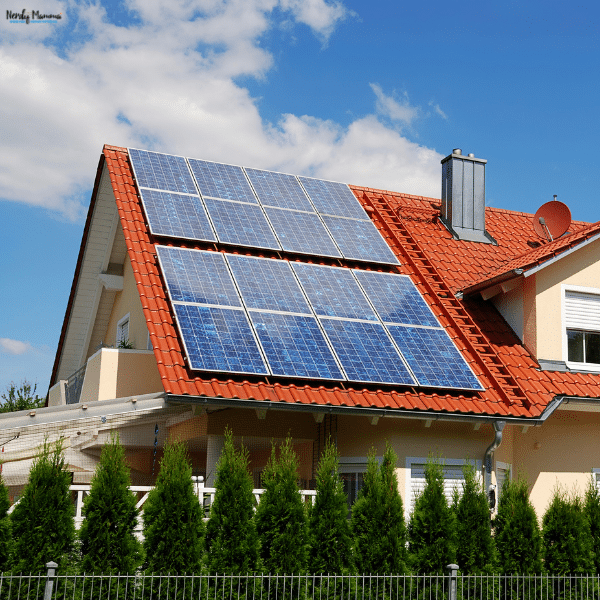 Solar panels cover a red tiled roof, showing a home energy system that could connect to a solar battery.